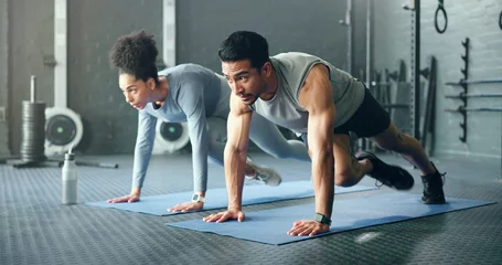 Fotobehang Sportschool Couple, fitness and gym workout of training friends together for a core strength exercise for abs. Strong, sports and athlete wellness cardio of people doing a sport in a health club or studio  © HockleyMedia/peopleimages.com