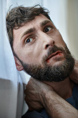 anxious depressed man in casual t shirt biting his lips till blood during breakdown, mental health