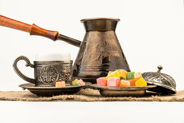 Turkish Coffee with Turkish Delight on authentic metal plate, isolated on white background