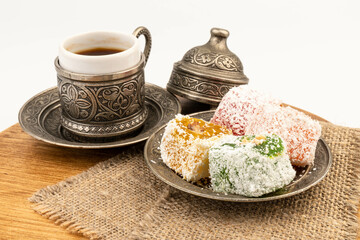 Turkish Coffee with Turkish Delight on authentic metal plate, isolated on white background