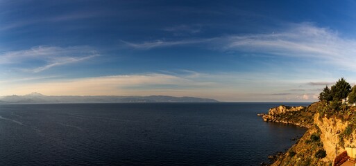 view of the Capo Milazzo peninsula in warm morning light - obrazy, fototapety, plakaty