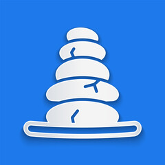 Paper cut Stack hot stones icon isolated on blue background. Spa salon accessory. Paper art style. Vector