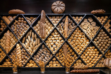 Assortment of breads on display, choice of different bread, bakery background