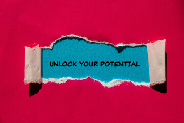 Unlock your potential lettering on ripped red paper with blue background. Conceptual business...