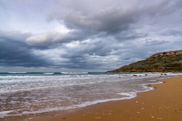 view of the red sand beach in idyllic Ramla Bay on Gozo Island in Malta