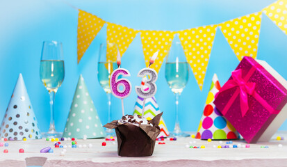 Date of birth for woman or girl with birthday box. Pie with number of candles  63. Anniversary greeting card with champagne. Holiday decorations. Happy birthday
