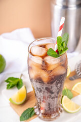 Fototapeta premium Cuba Libre or long island iced tea cocktail with strong drinks, cola, lime and ice in glass, cold long drink or lemonade
