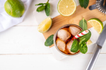 Cuba Libre or long island iced tea cocktail with strong drinks, cola, lime and ice in glass, cold long drink or lemonade