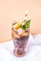 Cuba Libre or long island iced tea cocktail with strong drinks, cola, lime and ice in glass, cold long drink or lemonade