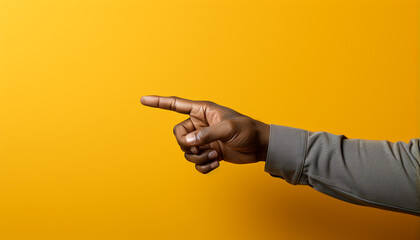 Fototapeta premium Young adult pointing finger, showing success, on yellow background generated by AI