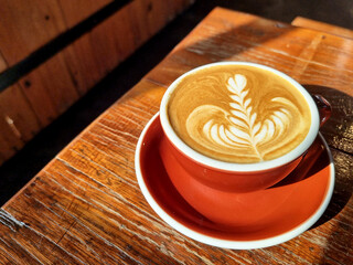 Sideway shop coffee, close-up hot latte art coffee on the wooden table