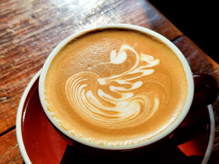Sideway shop coffee, Swan latte art coffee on the table.