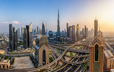 Panoramic sunset view of the modern skyline of Downtown Dubai, UAE, and Sheikh Zayed Road