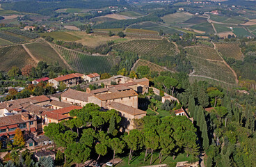 Fototapeta na wymiar Aerial view of the terracotta rooftops and vineyards of San Gimignano in Tuscany