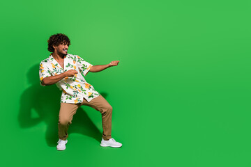 Full body photo of attractive young man pull empty space banner dressed stylish citrus print...