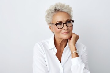 Portrait of beautiful senior businesswoman with eyeglasses looking at camera