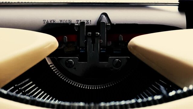 vintage typewriter type take your time sentence with ink, static shot