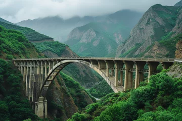 Fotobehang Mountainous region bridge, offering hikers and photographers panoramic views of majestic peaks and sprawling valleys, a popular spot for its breathtaking scenery and natural beauty. © Davivd