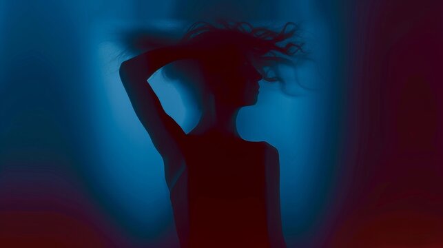 Female silhouette on a dark blue background. Elegant outline of a woman in motion out of focus