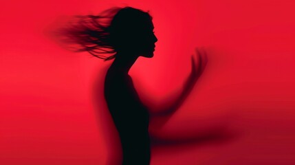 Female blurred silhouette on a red background. Elegant outline of a woman in motion out of focus