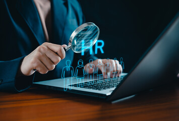 Human Resource Management concept. HRM. Businessman holding magnifier for searching to human icons for human development and recruitment concept. HR management. Cluster, consulting, business, people.