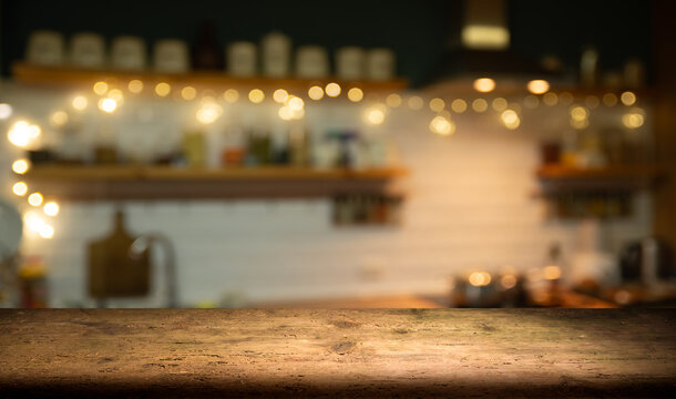 Empty wood table for product display in blur background of admirable restaurant at night. High quality photo