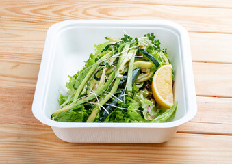 Salad mix of spaghetti with zucchini. Healthy food. Takeaway food. On a wooden background.