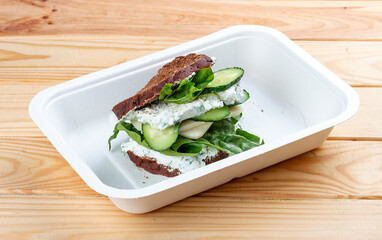 Multigrain toast with turkey. Healthy food. Takeaway food. On a wooden background.