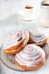 Delicious freshly baked buns with icing sugar. Confectionery products. Vertical photo.