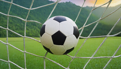 soccer ball in goal with green backgroung