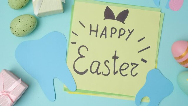 Dental layout with teeth figurines and postcard with Happy Easter text
