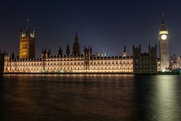 Fototapeta na wymiar A night time view of the Palace of Westminster or House of Parliament and Big Ben from the south bank of the Thames river.