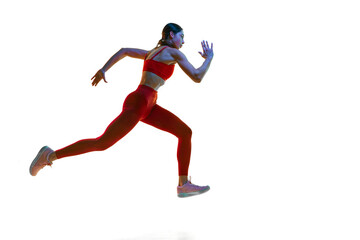 Fototapeta na wymiar Competitive, concentrated young woman, runner, athlete in motion training, running over white studio background in neon light. Concept of sport, active and healthy lifestyle, sportswear, competition