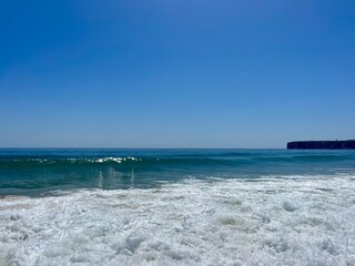 Blue sea horizon, sandy seashore, natural sea background, clear sky
