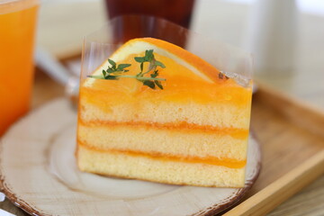 Close-up view of delicious orange cakes with orange juice placed on a wooden table in a cafe. Dessert concept. food