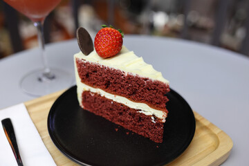 Close-up view of chocolate cake and sweet drink glasses placed on a wooden table in a cafe. Food concepts. Desserts