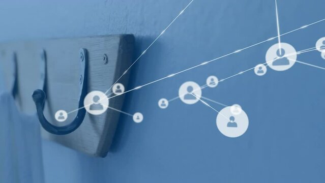 Animation of network of people icons over coat hooks on wall
