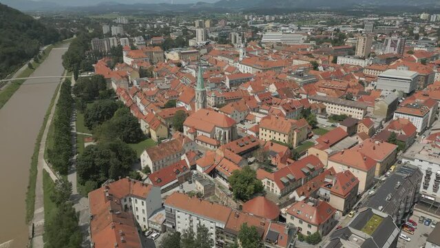 An aerial view of the beautiful city of Celje, Slovenia, reveals the ancient city nestled amidst a picturesque landscape.