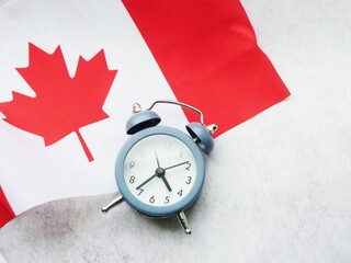 Canada time zone. Clock lay on the flag. Travel concept