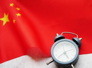 China time zone. Clock lay on the flag. Travel to Asia concept