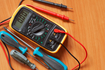 Digital multimeter and screwdrivers