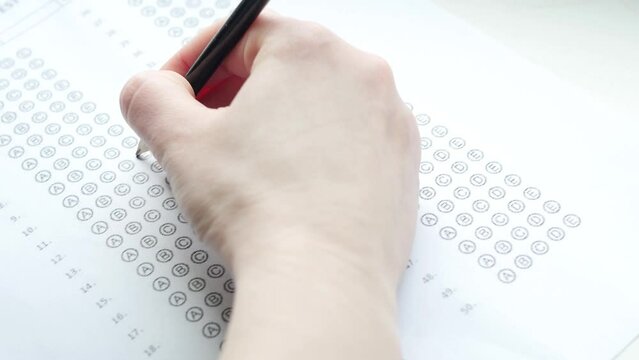 Close up student fill examination form. Education concept