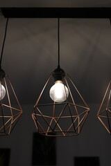 Stylish LED lamp in loft style. Chandelier in the shape of a crystal. Geometric shape of the chandelier. Room lighting.