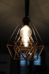 Stylish LED lamp in loft style. Chandelier in the shape of a crystal. Geometric shape of the...