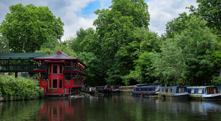 London - 29 05 2022: The Chinese Pagoda in the Cumberland Basin on the Regent's Canal with houseboats.