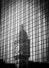 Paris, France. Reflection of clocktower of Gare de Lyon railway station in the skyscraper. Old times background. Postcard style black white historic photo..