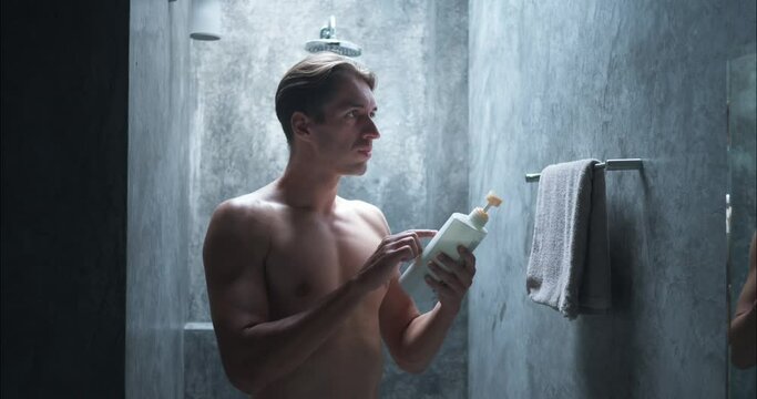 Man in bathroom looking to shower gel set for wash Stresses daily cleaning self-care health. Shower gel key for hygiene prevents diseases Shower gel essential in self-respect health routine.