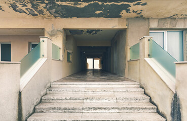 Dilapidated building, marble staircase, facade view