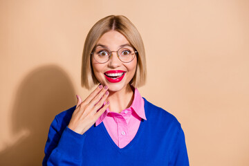 Portrait of astonished lovely girl beaming smile empty space unbelievable offer isolated on beige...