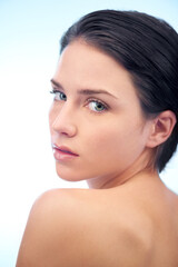 Obraz premium Health, skincare and portrait of woman in studio with beauty, cosmetic and face routine. Wellness, glow and confident young female person with facial salon dermatology treatment by blue background.